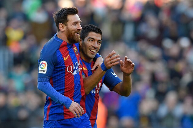 Barcelona's Uruguayan forward Luis Suarez celebrates with Barcelona's Argentinian forward Lionel Messi after scoring a goal during the Spanish league football match FC Barcelona vs UD Las Palmas at the Camp Nou stadium in Barcelona on January 14, 2017. / AFP / LLUIS GENE        (Photo credit should read LLUIS GENE/AFP/Getty Images)