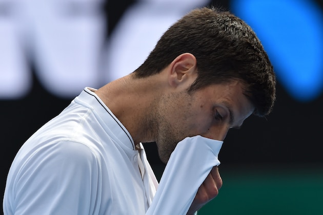 TOPSHOT - Serbia's Novak Djokovic reacts after a point against Uzbekistan's Denis Istomin during their men's singles match on day four of the Australian Open tennis tournament in Melbourne on January 19, 2017. / AFP / PAUL CROCK / IMAGE RESTRICTED TO EDITORIAL USE - STRICTLY NO COMMERCIAL USE        (Photo credit should read PAUL CROCK/AFP/Getty Images)