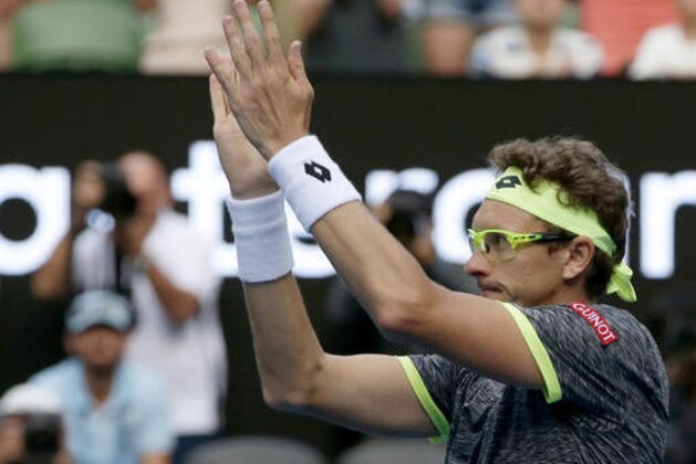 Uzbekistan's Denis Istomin celebrates after defeating Serbia's Novak Djokovic in their second round match at the Australian Open tennis championships in Melbourne, Australia, Thursday, Jan. 19, 2017. (AP Photo/Mark Baker)