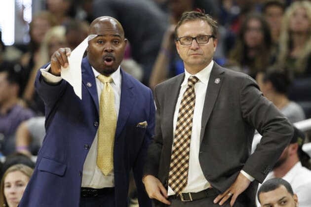 Washington Wizards head coach Scott Brooks, right, listens to assistant coach Sidney Lowe during the second half of an NBA basketball game against the Orlando Magic in Orlando, Fla., on Saturday, Nov. 5, 2016.  (AP Photo/Reinhold Matay)