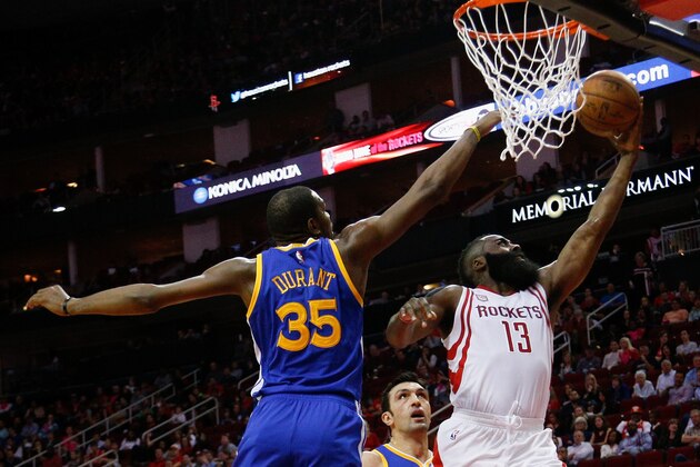 HOUSTON, TX - JANUARY 20:  James Harden #13 of the Houston Rockets drives past Kevin Durant #35 of the Golden State Warriors to the basket at Toyota Center on January 20, 2017 in Houston, Texas.  NOTE TO USER: User expressly acknowledges and agrees that, by downloading and/or using this photograph, user is consenting to the terms and conditions of the Getty Images License Agreement.  (Photo by Bob Levey/Getty Images)