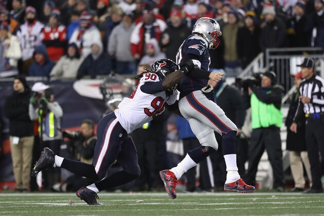 FOXBORO, MA - JANUARY 14: Tom Brady #12 of the New England Patriots is tackled by Jadeveon Clowney #90 of the Houston Texans in the second half during the AFC Divisional Playoff Game at Gillette Stadium on January 14, 2017 in Foxboro, Massachusetts.  (Photo by Rob Carr/Getty Images)