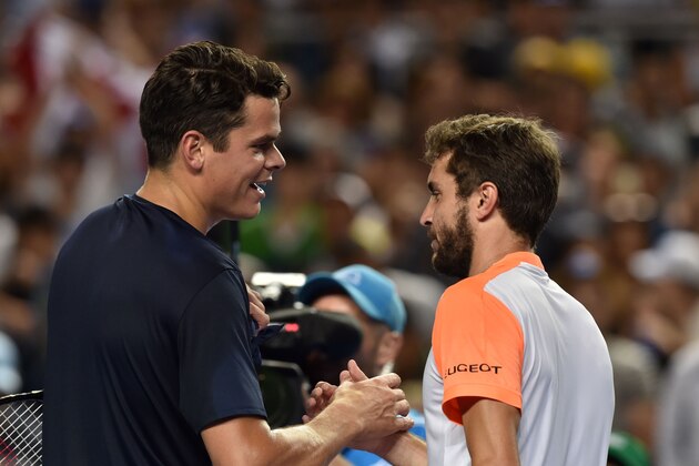 Canada's Milos Raonic (L) celebrates his victory against France's Gilles Simon during their men's singles third round match on day six of the Australian Open tennis tournament in Melbourne on January 21, 2017. / AFP / PAUL CROCK / IMAGE RESTRICTED TO EDITORIAL USE - STRICTLY NO COMMERCIAL USE        (Photo credit should read PAUL CROCK/AFP/Getty Images)