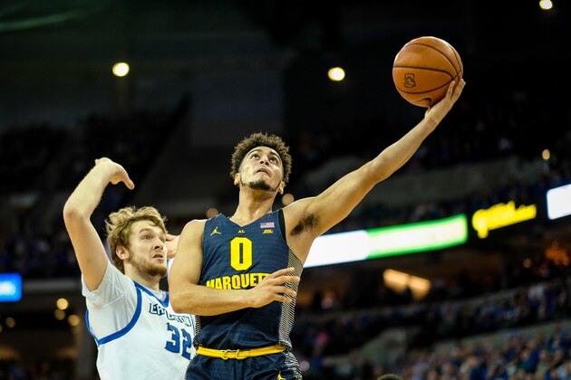OMAHA, NE - JANUARY 21: Markus Howard #0 of the Marquette Golden Eagles drives to the basket past Toby Hegner #32 of the Creighton Bluejays during their game at CenturyLink Center on January 21, 2017 in Omaha, Nebraska. (Photo by Eric Francis/Getty Images)
