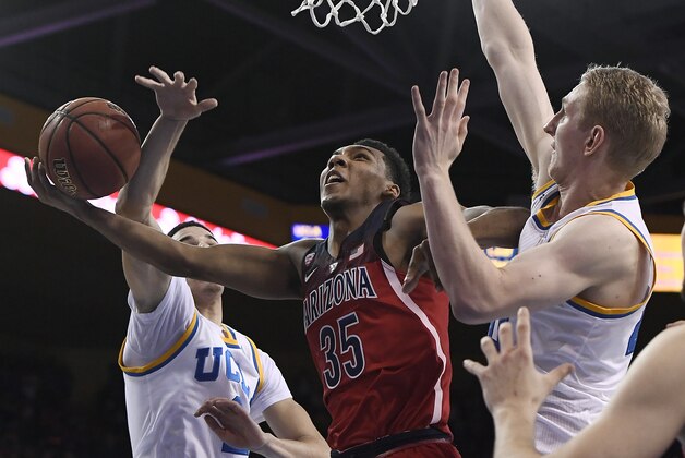 LOS ANGELES, CA - JANUARY 21: Allonzo Trier #35 of the Arizona Wildcats drives to the basket against Lonzo Ball #2 and Thomas Welsh #40 of the UCLA Bruins during the second half of the college basketball game at Pauley Pavilion on January 21, 2017 in Los Angeles, California. (Photo by Kevork Djansezian/Getty Images)
