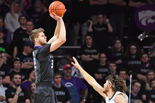 MANHATTAN, KS - JANUARY 21:  Forward Dean Wade #32 of the Kansas State Wildcats hits a three-point shot over forward Nathan Adrian #11 of the West Virginia Mountaineers during the first half on January 21, 2017 at Bramlage Coliseum in Manhattan, Kansas.  (Photo by Peter G. Aiken/Getty Images)