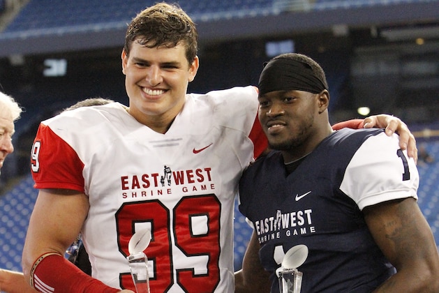 ST. PETERSBURG, FL - JANUARY 21:  East's Trey Hendrickson #99 of Florida Atlantic and West's Eli McGuire #1 of Louisiana-Lafayette pose as most valuable players of the East-West Shrine Game at Tropicana Field on January 21, 2017, in St. Petersburg, Florida. (Photo by Joseph Garnett, Jr. /Getty Images)