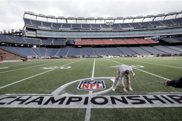 Worker Fred Fletcher, of Norwood, Mass., spray paints finishing touches on an AFC championship logo on the field at Gillette Stadium, Thursday, Jan. 19, 2017, in Foxborough, Mass. The Patriots host the Pittsburgh Steelers in the AFC championship game Sunday. (AP Photo/Steven Senne)