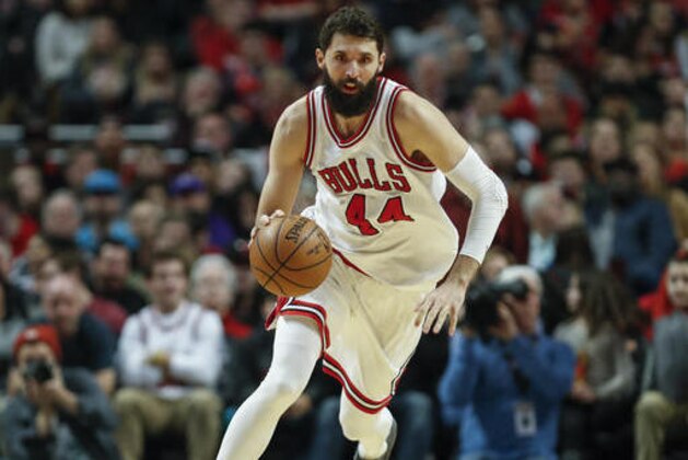 Chicago Bulls forward Nikola Mirotic brings the ball up court against the Charlotte Hornets during the second half of an NBA basketball game, Monday, Jan. 2, 2017, in Chicago. (AP Photo/Kamil Krzaczynski)