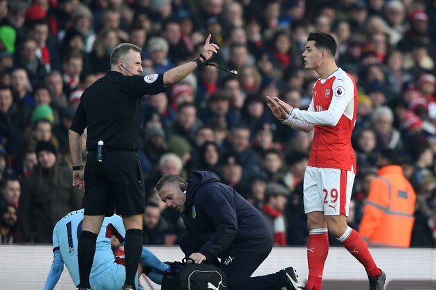 LONDON, ENGLAND - JANUARY 22:  Granit Xhaka (R) of Arsenal protests to referee Jonathan Moss after shown a red card during the Premier League match between Arsenal and Burnley at the Emirates Stadium on January 22, 2017 in London, England.  (Photo by Shaun Botterill/Getty Images)