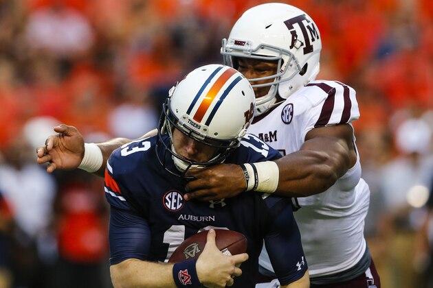 AUBURN, AL - SEPTEMBER 17:  Quarterback Sean White #13 of the Auburn Tigers is sacked by defensive lineman Myles Garrett #15 of the Texas A&M Aggies during an NCAA college football game on September 17, 2016 in Auburn, Alabama. (Photo by Butch Dill/Getty Images)