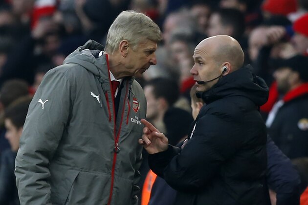 Fourth official Anthony Taylor (R) speaks to Arsenal's French manager Arsene Wenger (L) during the English Premier League football match between Arsenal and Burnley at the Emirates Stadium in London on January 22, 2017. 
Arsenal won the game 2-1. / AFP / Ian KINGTON / RESTRICTED TO EDITORIAL USE. No use with unauthorized audio, video, data, fixture lists, club/league logos or 'live' services. Online in-match use limited to 75 images, no video emulation. No use in betting, games or single club/league/player publications.  /         (Photo credit should read IAN KINGTON/AFP/Getty Images)