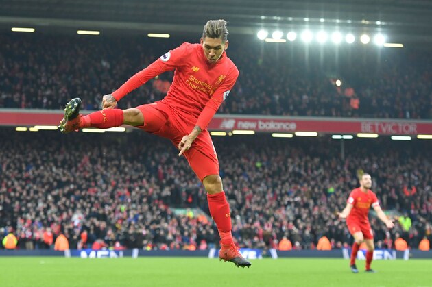 Liverpool's Brazilian midfielder Roberto Firmino celebrates scoring their second goal to equalise 2-2 during the English Premier League football match between Liverpool and Swansea City at Anfield in Liverpool, north west England on January 21, 2017. / AFP / Anthony DEVLIN / RESTRICTED TO EDITORIAL USE. No use with unauthorized audio, video, data, fixture lists, club/league logos or 'live' services. Online in-match use limited to 75 images, no video emulation. No use in betting, games or single club/league/player publications.  /         (Photo credit should read ANTHONY DEVLIN/AFP/Getty Images)