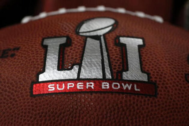 The first NFL Super Bowl LI football sits in a bin with other balls to be stamped with the New England Patriots and Atlanta Falcons names at the Wilson Sporting Goods factory Sunday, Jan. 22, 2017, in Ada, Ohio. (AP Photo/Charles Rex Arbogast)