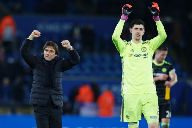 Chelsea's Italian head coach Antonio Conte (L) and Chelsea's Belgian goalkeeper Thibaut Courtois (R) celebrate on the pitch after the English Premier League football match between Leicester City and Chelsea at King Power Stadium in Leicester, central England on January 14, 2017.
Cheslea won the game 3-0. / AFP / Adrian DENNIS / RESTRICTED TO EDITORIAL USE. No use with unauthorized audio, video, data, fixture lists, club/league logos or 'live' services. Online in-match use limited to 75 images, no video emulation. No use in betting, games or single club/league/player publications.  /         (Photo credit should read ADRIAN DENNIS/AFP/Getty Images)