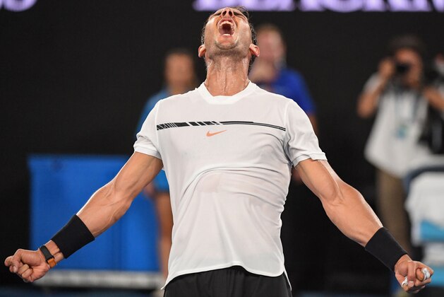 TOPSHOT - Spain's Rafael Nadal celebrates his victory against France's Gael Monfils during their men's singles fourth round match on day eight of the Australian Open tennis tournament in Melbourne on January 23, 2017. / AFP / SAEED KHAN / IMAGE RESTRICTED TO EDITORIAL USE - STRICTLY NO COMMERCIAL USE        (Photo credit should read SAEED KHAN/AFP/Getty Images)