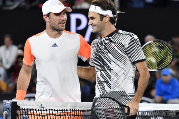 Switzerland's Roger Federer, right, is congratulated by Germany's Mischa Zverev after winning their quarterfinal at the Australian Open tennis championships in Melbourne, Australia, Tuesday, Jan. 24, 2017. (AP Photo/Andy Brownbill)