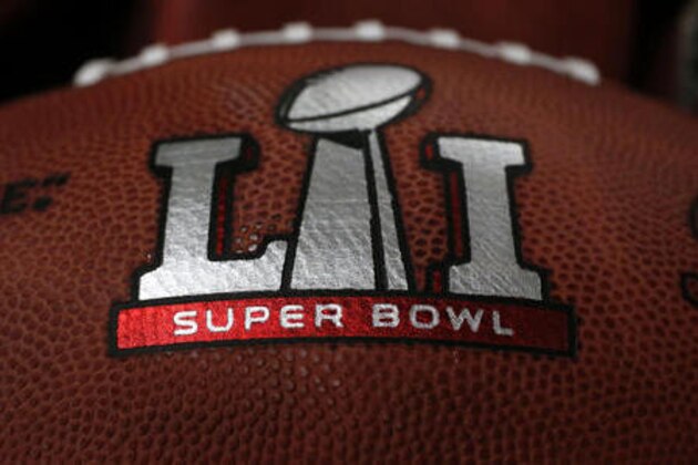 The first NFL Super Bowl LI football sits in a bin with other balls to be stamped with the New England Patriots and Atlanta Falcons names at the Wilson Sporting Goods factory Sunday, Jan. 22, 2017, in Ada, Ohio. (AP Photo/Charles Rex Arbogast)