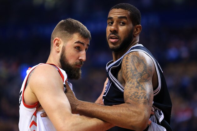 TORONTO, ON - JANUARY 24:  Jonas Valanciunas #17 of the Toronto Raptors battles for room with LaMarcus Aldridge #12 of the San Antonio Spurs during the first half of an NBA game at Air Canada Centre on January 24, 2017 in Toronto, Canada.  NOTE TO USER: User expressly acknowledges and agrees that, by downloading and or using this photograph, User is consenting to the terms and conditions of the Getty Images License Agreement.  (Photo by Vaughn Ridley/Getty Images)