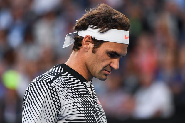 Switzerland's Roger Federer prepares to play a point against Germany's Mischa Zverev during their men's singles quarter-final match on day nine of the Australian Open tennis tournament in Melbourne on January 24, 2017. / AFP / SAEED KHAN / IMAGE RESTRICTED TO EDITORIAL USE - STRICTLY NO COMMERCIAL USE        (Photo credit should read SAEED KHAN/AFP/Getty Images)