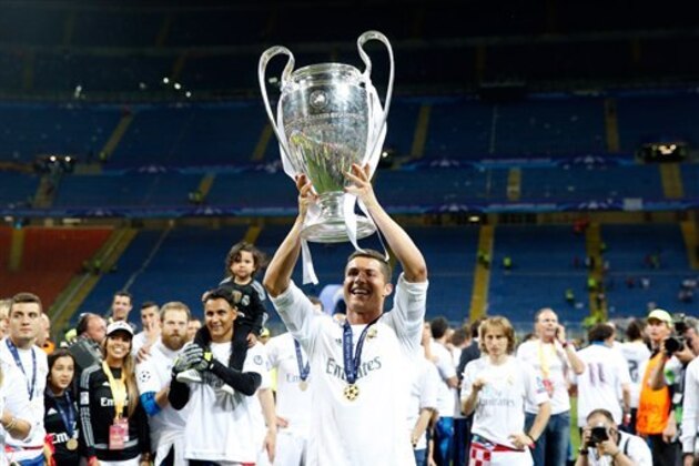 Real Madrid's Cristiano Ronaldo celebrates with the trophy after the Champions League final soccer match between Real Madrid and Atletico Madrid at the San Siro stadium in Milan, Italy, Saturday, May 28, 2016. Real Madrid won 5-3 on penalties after the match ended 1-1 after extra time.   (AP Photo/Antonio Calanni)