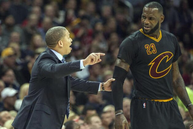 Cleveland Cavaliers head coach Tyronn Lue talks with LeBron James during the second half of an NBA basketball game against the Atlanta Hawks in Cleveland, Tuesday, Nov. 8, 2016. The Hawks won 110-106. (AP Photo/Phil Long)
