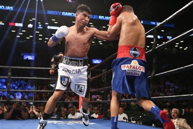 Mikey Garcia, left, throws a punch at Elio Rojas during their fight at the Barclays Center in the Brooklyn borough of New York on Saturday, July 30, 2016. Mikey Garcia won via knockout. (AP Photo/Steve Luciano)