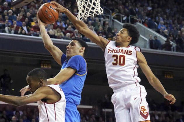 Southern California guard Elijah Stewart (30) gets a hand on the ball as UCLA guard Lonzo Ball (2) shoots during the first half of an NCAA college basketball game in Los Angeles on Wednesday, Jan. 25, 2017. (AP Photo/Reed Saxon) Southern California guard Elijah Stewart (30) gets a hand on the ball as UCLA guard Lonzo Ball (2) shoots during the first half of an NCAA college basketball game in Los Angeles on Wednesday, Jan. 25, 2017. (AP Photo/Reed Saxon)