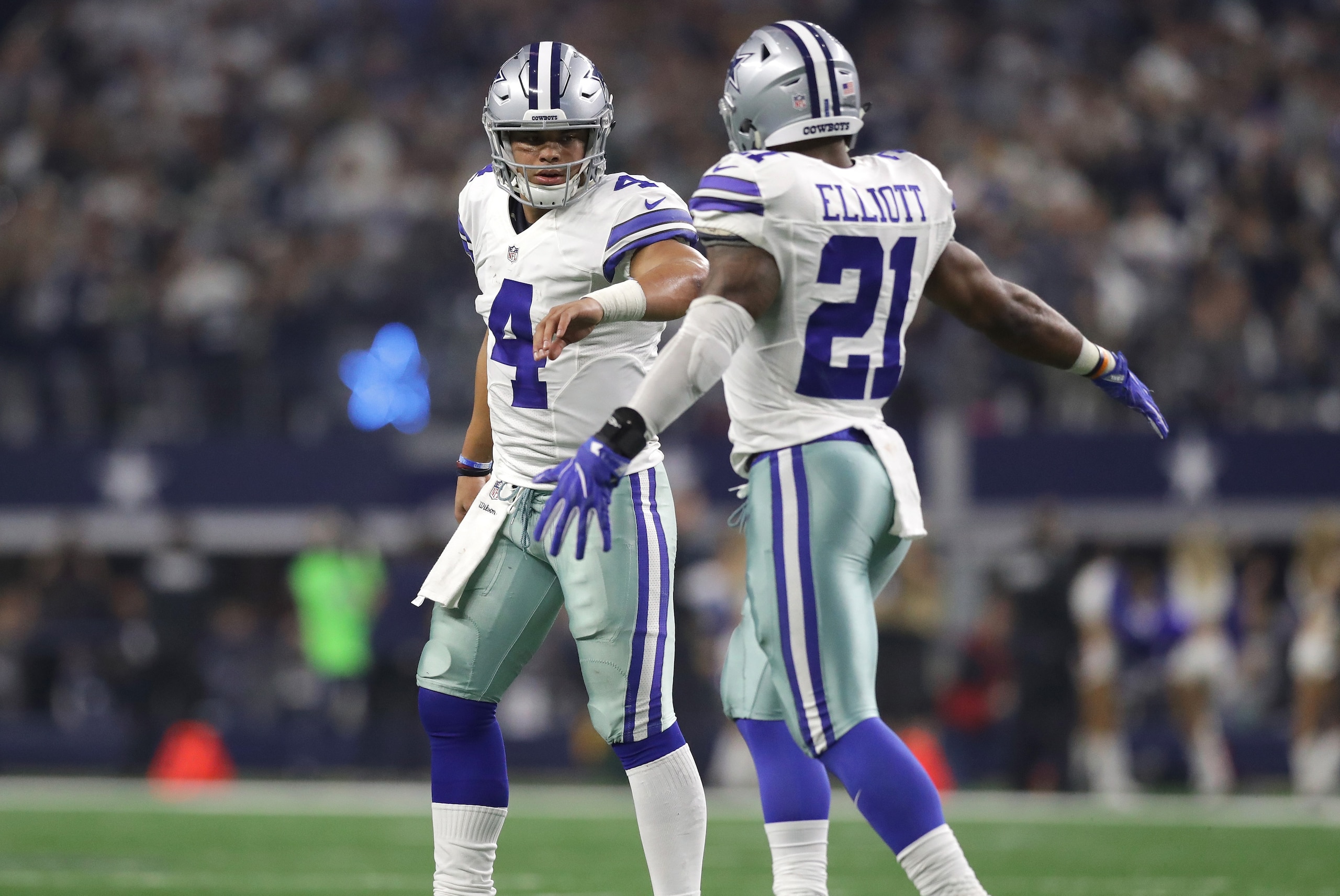 ARLINGTON, TX - JANUARY 15: Ezekiel Elliott #21 and Dak Prescott #4 of the Dallas Cowboys celebrate after a first down during the third quarter against the Green Bay Packers in the NFC Divisional Playoff game at AT&T Stadium on January 15, 2017 in Arlington, Texas. (Photo by Ronald Martinez/Getty Images) ARLINGTON, TX - JANUARY 15: Ezekiel Elliott #21 and Dak Prescott #4 of the Dallas Cowboys celebrate after a first down during the third quarter against the Green Bay Packers in the NFC Divisional Playoff game at AT&T Stadium on January 15, 2017 in Arlington, Texas. (Photo by Ronald Martinez/Getty Images)