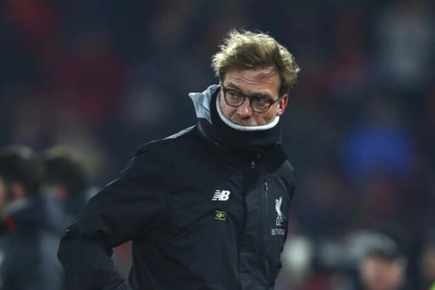 Liverpool's head coach Juergen Klopp leaves the pitch before kick off in the English League Cup semifinal 2nd leg soccer match between Liverpool and Southampton at Anfield stadium in Liverpool, England, Wednesday, Jan. 25, 2017. (AP Photo/Dave Thompson)