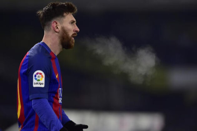 FC Barcelona's Lionel Messi, exhales cold air during the Spanish Copa del Rey, quarter final, first leg soccer match, between FC Barcelona and Real Sociedad, at Anoeta stadium, in San Sebastian, northern Spain, Thursday, Jan. 19, 2017. (AP Photo/Alvaro Barrientos)
