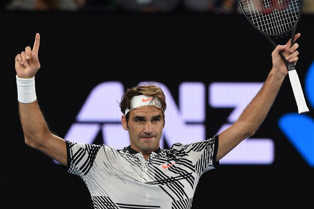 Switzerland's Roger Federer celebrates his win against Switzerland's Stanislas Wawrinka during their men's singles semi-final match on day 11 of the Australian Open tennis tournament in Melbourne on January 26, 2017. / AFP / PAUL CROCK / IMAGE RESTRICTED TO EDITORIAL USE - STRICTLY NO COMMERCIAL USE        (Photo credit should read PAUL CROCK/AFP/Getty Images)