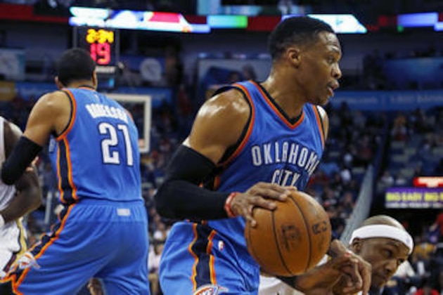 Oklahoma City Thunder guard Russell Westbrook, center, dribbles past New Orleans Pelicans forward Dante Cunningham (33) in the first half of an NBA basketball game in New Orleans, Wednesday, Jan. 25, 2017. (AP Photo/Max Becherer)