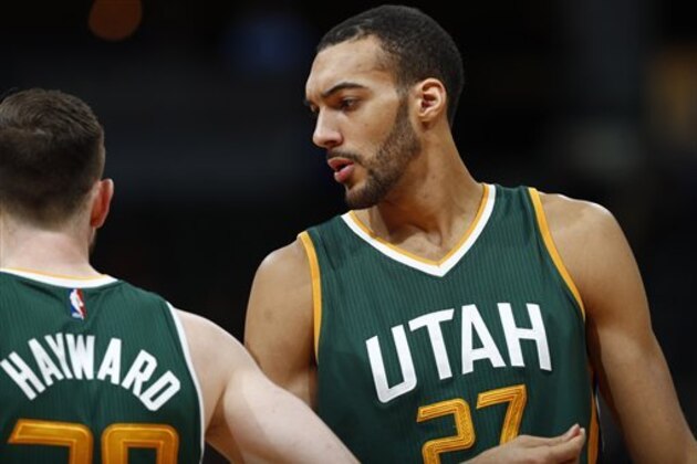 Utah Jazz forward Gordon Hayward (20) and Utah Jazz center Rudy Gobert (27)  in the second half of an NBA basketball game Tuesday, Jan. 24, 2017, in Denver. The Nuggets won 103-93. (AP Photo/David Zalubowski)
