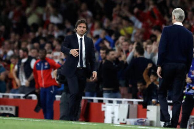 Chelsea team manager Antonio Conte, left, shakes hands with Arsenal team manager Arsene Wenger at the end of the English Premier League soccer match between Arsenal and Chelsea at the Emirates Stadium in London, Saturday, Sept. 24, 2016. Arsenal won 3-0. (AP Photo/Matt Dunham)