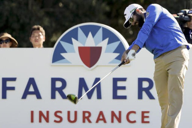 Adam Hadwin, of Canada, hits his tee shot on the 18th hole of the south course during the first round of the Farmers Insurance Open golf tournament Thursday, Jan. 26, 2017, at Torrey Pines Golf Course in San Diego. (AP Photo/Gregory Bull)