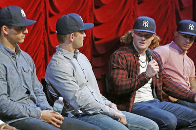 From left, New York Yankees prospects James Kaprielian, Chance Adams, Clint Frazier and Gleyber Torres appear on stage together at the Hard Rock Cafe, Tuesday, Jan. 17, 2017, in New York. Rather than bring veterans, the Yankees had the four respond to fans' question at a town hall meeting along with Starlin Castro and general manager Brian Cashman. They hope the rebuilding club transforms into a power resembling the teams that won four World Series titles from 1996-2000, one opposing fans will hate but respect. (AP Photo/Kathy Willens)