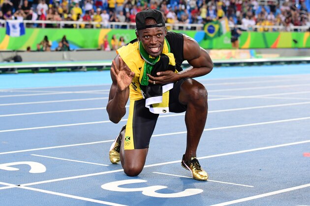 Jamaica's Usain Bolt holds up three fingers for a third relay Olympic title after Team Jamaica won the Men's 4x100m Relay Final during the athletics event at the Rio 2016 Olympic Games at the Olympic Stadium in Rio de Janeiro on August 19, 2016.  / AFP / FRANCK FIFE        (Photo credit should read FRANCK FIFE/AFP/Getty Images)
