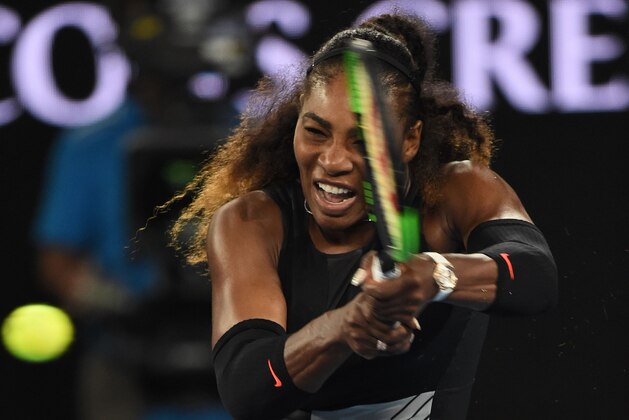 Serena Williams of the US hits a return against Venus Williams of the US during the women's singles final on day 13 of the Australian Open tennis tournament in Melbourne on January 28, 2017. / AFP / PAUL CROCK / IMAGE RESTRICTED TO EDITORIAL USE - STRICTLY NO COMMERCIAL USE        (Photo credit should read PAUL CROCK/AFP/Getty Images)
