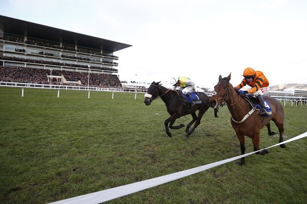 CHELTENHAM, ENGLAND - JANUARY 28:   Leighton Aspell riding Many Clouds (L, yellow/green) clear the last to win The BetBright Trial Cotswold Steeple Chase from Thistlecrack (orange) at Cheltenham Racecourse on January 28, 2017 in Cheltenham, England. (Photo by Alan Crowhurst/Getty Images)