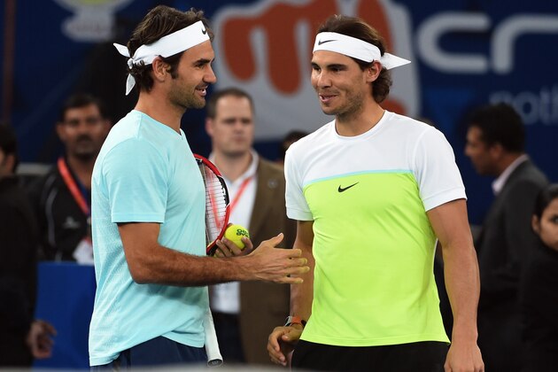 Spain's Rafael Nadal of the Indian Aces (R) and Switzerland's Roger Federer of the Japan Warriors greet each other during practice at the International Premier Tennis League (IPTL) event in New Delhi on December 12, 2015. AFP PHOTO / SAJJAD HUSSAIN / AFP / SAJJAD HUSSAIN        (Photo credit should read SAJJAD HUSSAIN/AFP/Getty Images)
