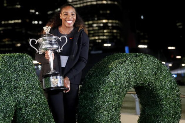 United States' Serena Williams poses with her trophy after defeating her sister Venus to win the women's singles final at the Australian Open tennis championships in Melbourne, Australia, Sunday, Jan. 29, 2017. (AP Photo/Dita Alangkara)