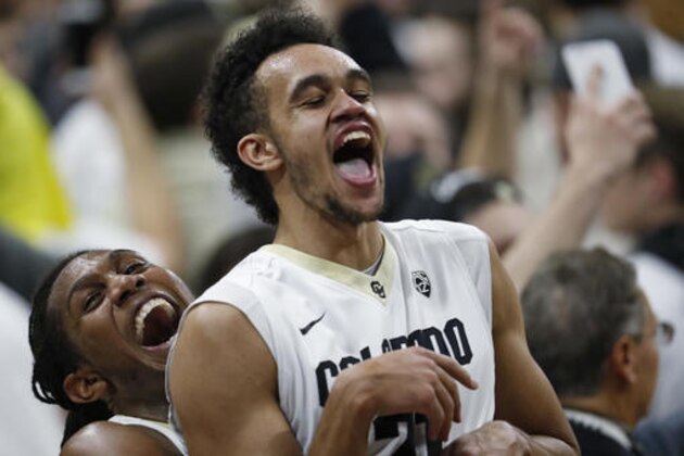 Colorado guard Xavier Johnson, left, hoists guard Derrick White at the end of the team's NCAA college basketball game against Oregon on Saturday, Jan. 28, 2017, in Boulder, Colo. Colorado won 74-65. (AP Photo/David Zalubowski)