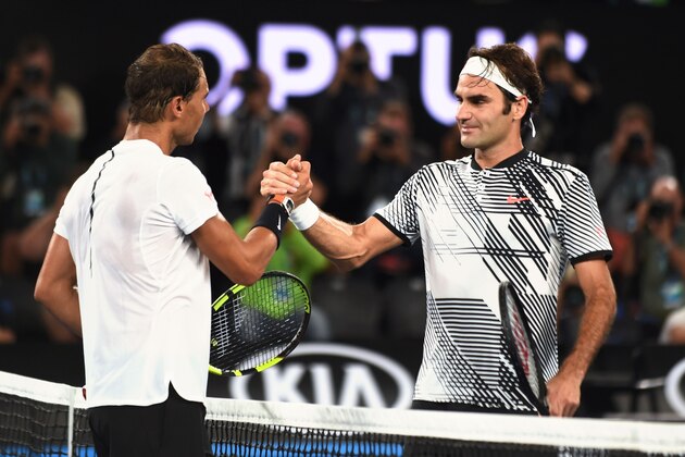 Switzerland's Roger Federer (R) is congratulated by Spain's Rafael Nadal after winning their men's singles final match on day 14 of the Australian Open tennis tournament in Melbourne on January 29, 2017. / AFP / PAUL CROCK / IMAGE RESTRICTED TO EDITORIAL USE - STRICTLY NO COMMERCIAL USE        (Photo credit should read PAUL CROCK/AFP/Getty Images)