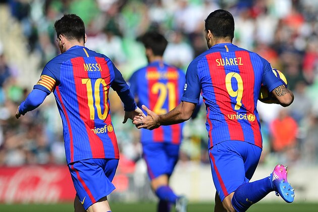Barcelona's Uruguayan forward Luis Suarez (R) celebrates a goal with Barcelona's Argentinian forward Lionel Messi (L) during the Spanish league football match Real Betis vs FC Barcelona at the Benito Villamarin stadium in Sevilla on January 29, 2017. / AFP / CRISTINA QUICLER        (Photo credit should read CRISTINA QUICLER/AFP/Getty Images)