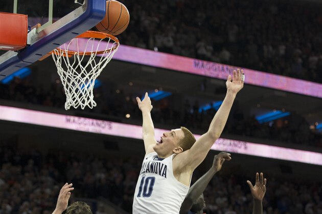 PHILADELPHIA, PA - JANUARY 29: Donte DiVincenzo #10 of the Villanova Wildcats tips in the game winning basket as time expired against Ty Jerome #11 and Marial Shayok #4 of the Virginia Cavaliers at the Wells Fargo Center on January 29, 2017 in Villanova, Pennsylvania. The Wildcats defeated the Cavaliers 61-59. (Photo by Mitchell Leff/Getty Images)