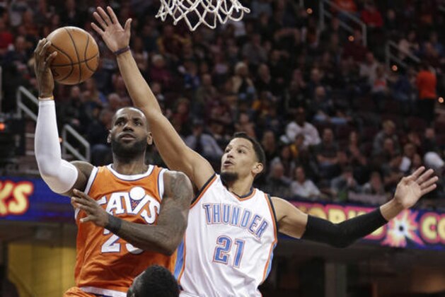 Cleveland Cavaliers' LeBron James (23) drives to the basket against Oklahoma City Thunder' Andre Roberson (21) in the first half of an NBA basketball game, Sunday, Jan. 29, 2017, in Cleveland. (AP Photo/Tony Dejak)