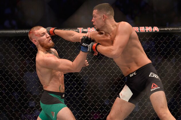 LAS VEGAS, NV - AUGUST 20:   (R-L) Nate Diaz punches Conor McGregor  in their welterweight bout during the UFC 202 event at T-Mobile Arena on August 20, 2016 in Las Vegas, Nevada. (Photo by Brandon Magnus/Zuffa LLC/Zuffa LLC via Getty Images)