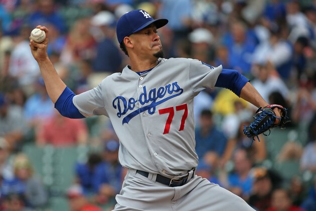 CHICAGO, IL - JUNE 25:  Starting pitcher Carlos Frias #77 of the Los Angeles Dodgers delivers the ball against the Chicago Cubs at Wrigley Field on June 25, 2015 in Chicago, Illinois.  (Photo by Jonathan Daniel/Getty Images)