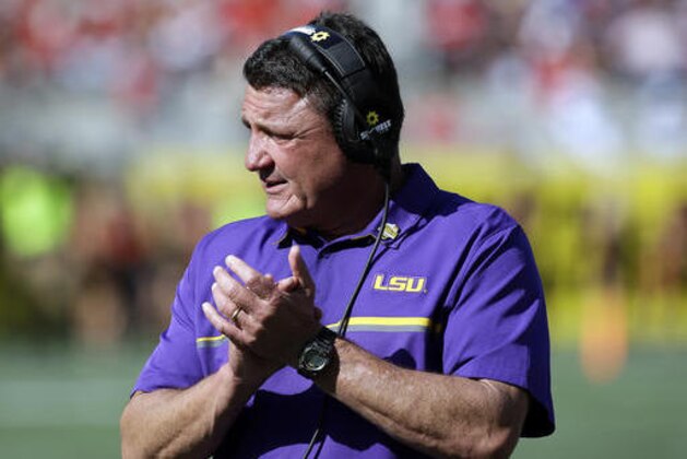 LSU head coach Ed Orgeron encourages players during the second half of the Citrus Bowl NCAA football game against Louisville, Saturday, Dec. 31, 2016, in Orlando, Fla. LSU won 29-9. (AP Photo/John Raoux)